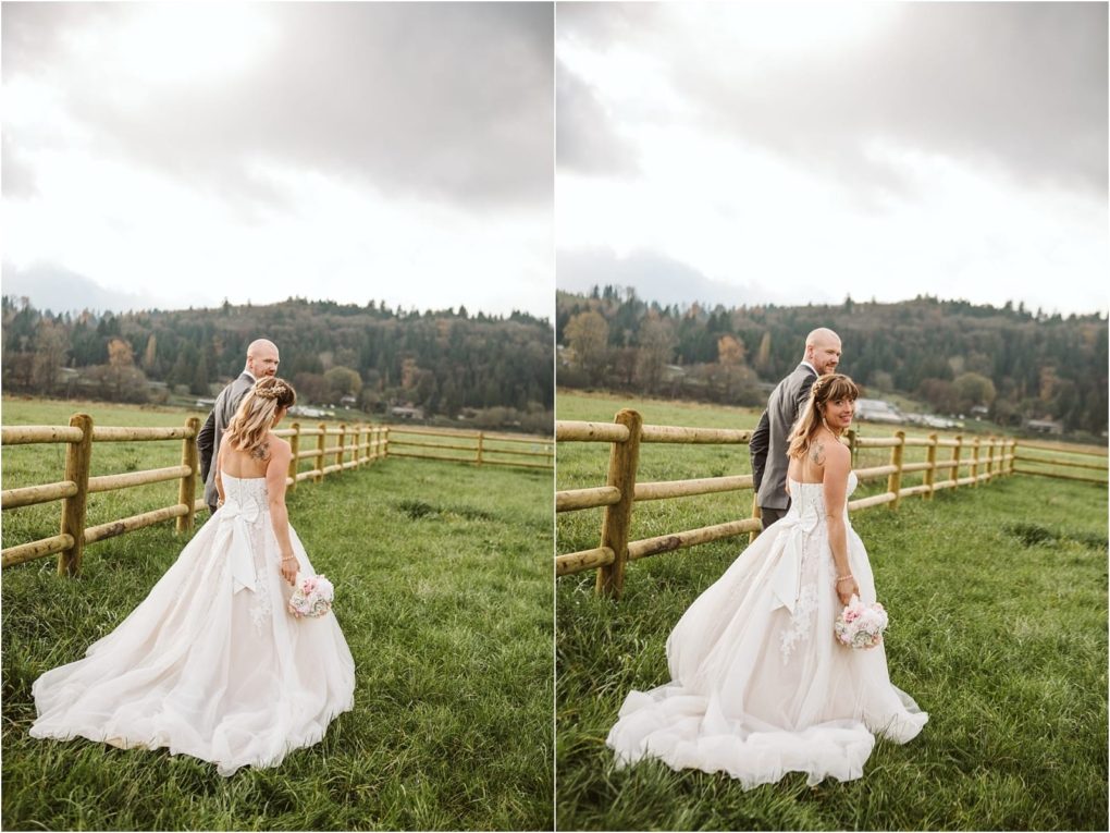 Premier snohomish & seattle wedding photographer | gsquared weddings photography a bride in a white dress holding a bouquet walks with her groom in a gray suit along a wooden fence in a grassy snohomish field with trees and hills in the background under a cloudy skyperfect for a seattle wedding engagement | serving snohomish seattle                   & beyond