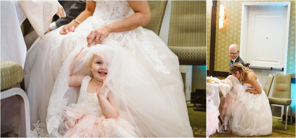 Premier snohomish & seattle wedding photographer | gsquared weddings photography a smiling young girl in a pink dress sits on the floor playfully holding a bridal veil beside a bride at a snohomish seattle wedding another photo captures the bride bending down near her during the lively reception | serving snohomish seattle                   & beyond