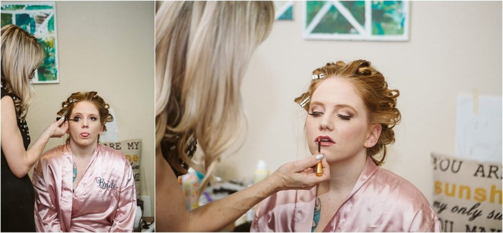 Premier snohomish & seattle wedding photographer | gsquared weddings photography a woman with red hair in a pink satin robe gets her makeup done by a blonde stylist before her snohomish seattle wedding In the left image she makes a funny face in the right she sits still while lipstick is applied | serving snohomish seattle                   & beyond