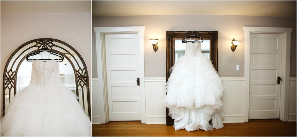 Premier snohomish & seattle wedding photographer | gsquared weddings photography a white strapless wedding dress with a full layered skirt hangs on a black hanger in front of a large mirror between two white doors in a softly lit snohomish room with wood floors perfect for a seattle wedding engagement | serving snohomish seattle                   & beyond