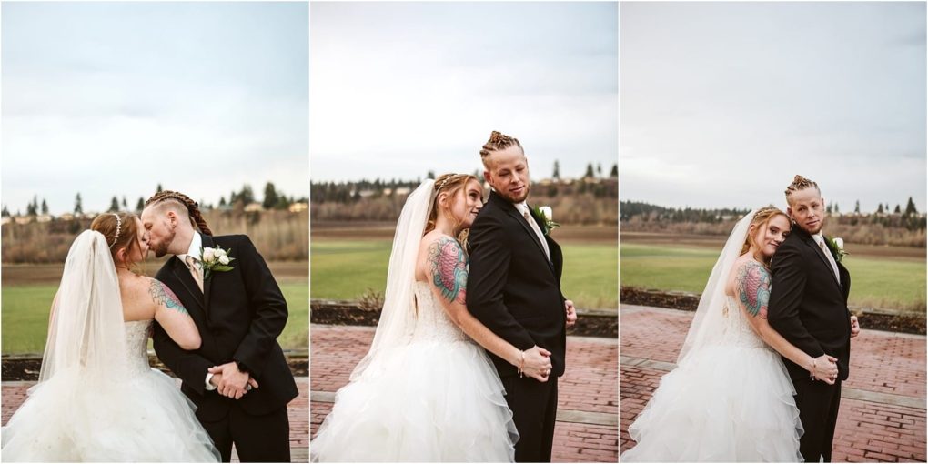 Premier snohomish & seattle wedding photographer | gsquared weddings photography a newlywed couple poses outdoors in wedding attire at their snohomish seattle wedding The bride wears a white gown and veil showing colorful tattoos while the groom wears a black suit and boutonniere They hold hands and smile affectionately | serving snohomish seattle                   & beyond