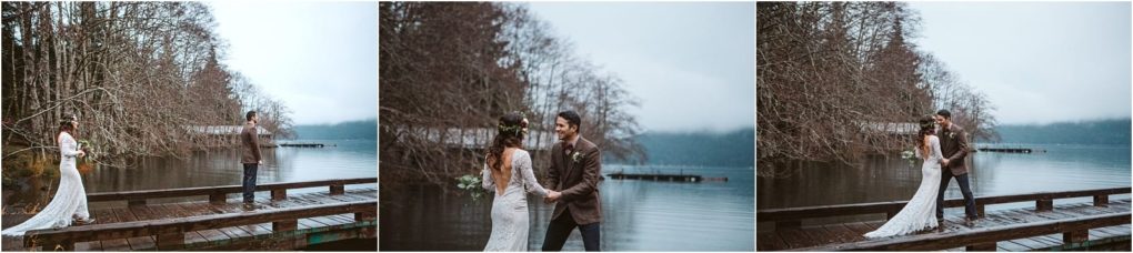 Premier snohomish & seattle wedding photographer | gsquared weddings photography a bride and groom stand on a wooden dock by a lake near snohomish surrounded by bare trees on a cloudy day The bride wears a lace gown and floral crown the groom in a casual brown jacket They face each other and hold hands capturing seattle wedding magic | serving snohomish seattle                   & beyond