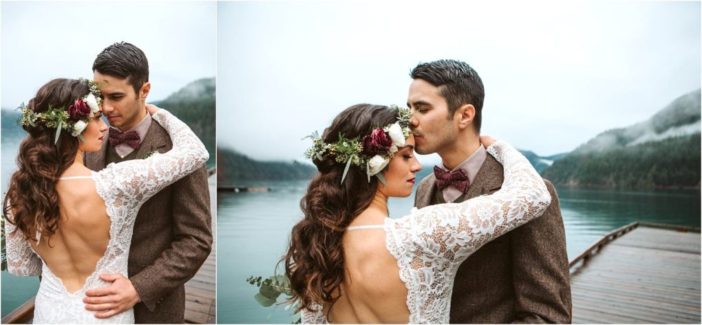 Premier snohomish & seattle wedding photographer | gsquared weddings photography a bride in a lace dress and floral crown embraces her groom in a brown suit on a wooden dock by a misty lakean enchanting snohomish seattle wedding moment framed by green forested mountains under an overcast sky | serving snohomish seattle                   & beyond