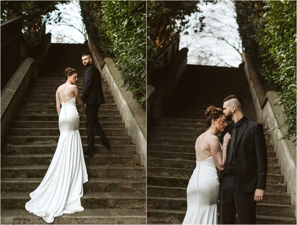 Premier snohomish & seattle wedding photographer | gsquared weddings photography a couple poses on outdoor stone steps surrounded by greenery in snohomish the woman wears a fitted white gown with a long train and the man wears a black suit They hold hands and gaze at each other affectionately during their seattle wedding engagement | serving snohomish seattle                   & beyond