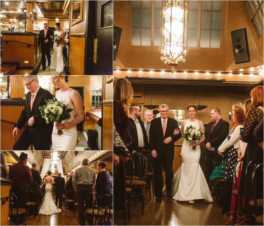 Premier snohomish & seattle wedding photographer | gsquared weddings photography a bride in a white dress walks down the aisle with an older man at a warmly lit snohomish wedding venue near seattle surrounded by standing guests and wooden walls aglow with string lights She holds a bouquet of white flowers | serving snohomish seattle                   & beyond
