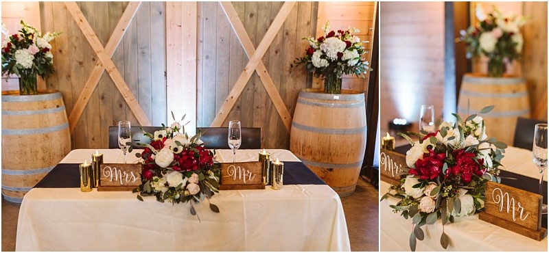Premier snohomish & seattle wedding photographer | gsquared weddings photography a sweetheart table with a white tablecloth floral centerpiece of red and white flowers mr  and mrs  signs champagne glasses and gold candlesperfect for a snohomish seattle wedding Wooden barrels and flower arrangements add rustic charm in the background | serving snohomish seattle                   & beyond
