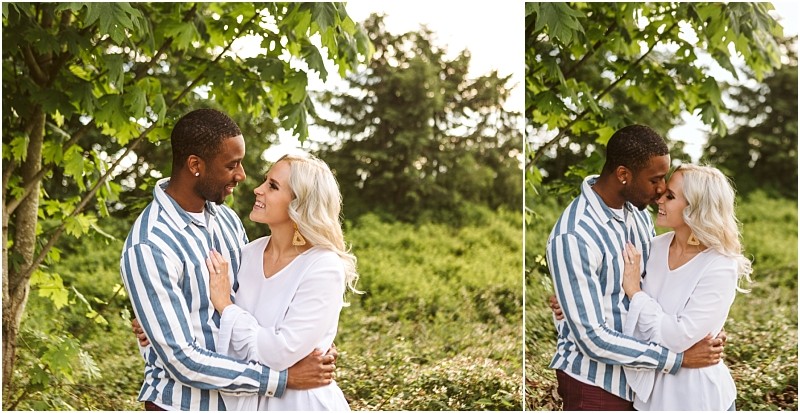 Premier snohomish & seattle wedding photographer | gsquared weddings photography a couple stands outdoors embracing and smiling under a leafy tree surrounded by greenery They appear happy and affectionatecapturing the warmth of a snohomish seattle wedding engagement moment The man wears a striped shirt the woman a white top | serving snohomish seattle                   & beyond