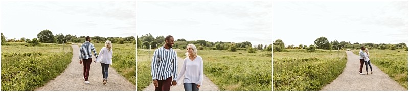 Premier snohomish & seattle wedding photographer | gsquared weddings photography a couple walks hand in hand through a green open field under a cloudy sky smiling at each other during their snohomish seattle wedding engagement | serving snohomish seattle                   & beyond