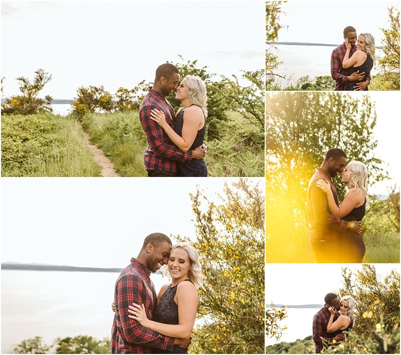 Premier snohomish & seattle wedding photographer | gsquared weddings photography a couple embraces and smiles at each other outdoors near greenery and water captured in warm sunlit poses along a scenic pathway in snohomish seattle with golden sunlight filtering through treesperfect for a wedding engagement session | serving snohomish seattle                   & beyond