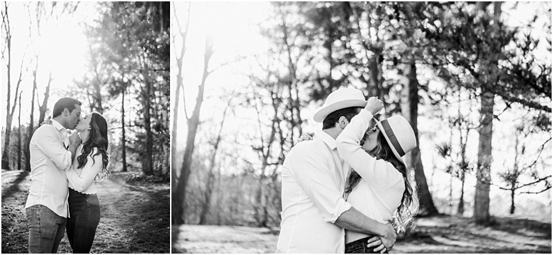 Premier snohomish & seattle wedding photographer | gsquared weddings photography black and white photos of a couple kissing outdoors on a sunlit path surrounded by trees Perfect for a snohomish seattle wedding engagement they embrace closely in casual clothes and hats as sunlight filters through the leaves | serving snohomish seattle                   & beyond
