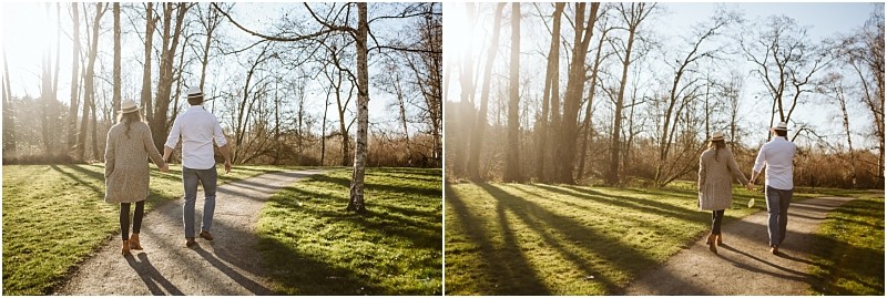 Premier snohomish & seattle wedding photographer | gsquared weddings photography two people wearing hats and casual clothes walk hand in hand down a sunlit tree lined path in a park near snohomish The light casts long shadows and the trees are bare evoking an early spring or late autumn seattle engagement session | serving snohomish seattle                   & beyond