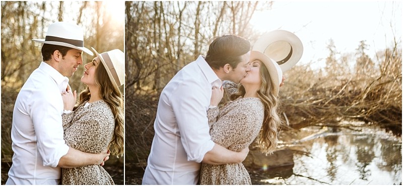 Premier snohomish & seattle wedding photographer | gsquared weddings photography a couple embraces and kisses outdoors by a creek near snohomish both wearing hats and casual clothes with warm sunlight filtering through treesa perfect seattle wedding engagement moment | serving snohomish seattle                   & beyond