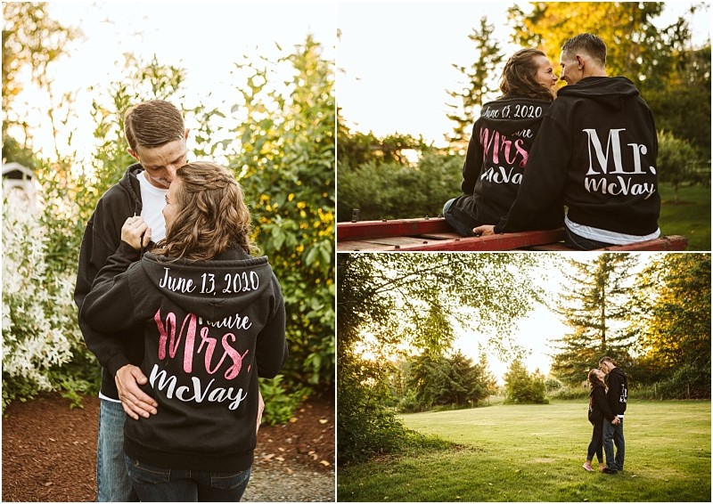 Premier snohomish & seattle wedding photographer | gsquared weddings photography a couple wearing matching custom black hoodies featuring mr Mcvay and future mrs Mcvay with the date june 13 2020 embrace in a sunlit green outdoor settingperfect for a snohomish seattle wedding engagement moment | serving snohomish seattle                   & beyond