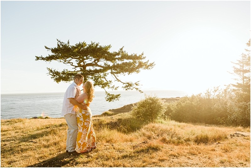 Premier snohomish & seattle wedding photographer | gsquared weddings photography a couple embraces and smiles at each other on a grassy hill near the ocean with a large tree and bright sunlight in the background Perfect for a snohomish seattle wedding engagement session she wears a yellow dress he wears a white shirt and light pants | serving snohomish seattle & beyond Premier snohomish & seattle wedding photographer | gsquared weddings photography a couple embraces and smiles at each other on a grassy hill near the ocean with a large tree and bright sunlight in the background Perfect for a snohomish seattle wedding engagement session she wears a yellow dress he wears a white shirt and light pants | serving snohomish seattle & beyond