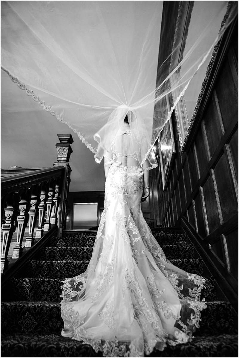 Thornewood castle wedding bride with a veil on the staircase