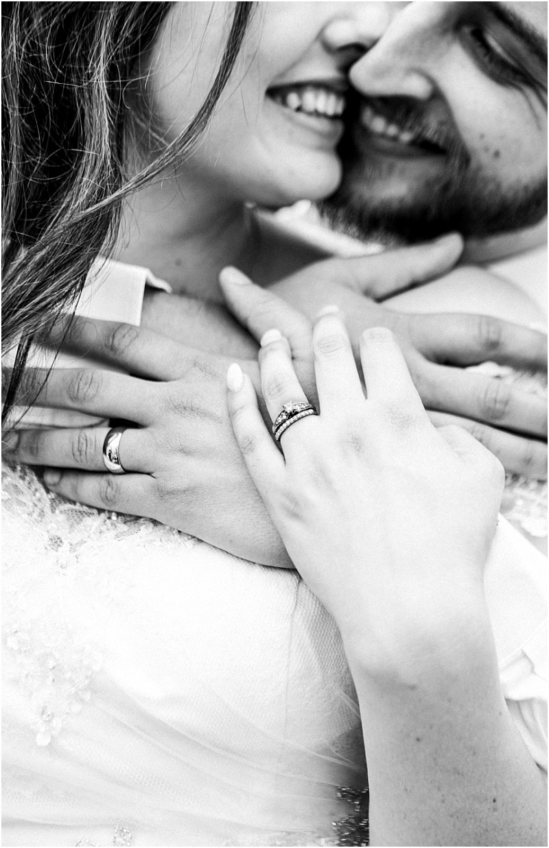 Premier snohomish & seattle wedding photographer | gsquared weddings photography black and white photo of a couple embracing closely smiling with their faces touching Their hands adorned with wedding rings are gently clasped together in the foreground capturing snohomish seattle wedding intimacy and love | serving snohomish seattle                   & beyond