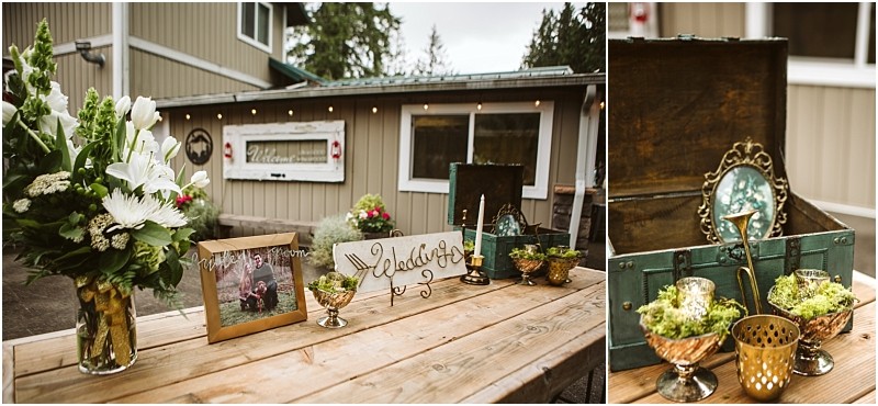 Premier snohomish & seattle wedding photographer | gsquared weddings photography a rustic snohomish wedding welcome table decorated with flowers a framed photo candles greenery and vintage itemsincluding a teal chest gold cups and a small mirrorset before a charming beige building near seattle | serving snohomish seattle                   & beyond