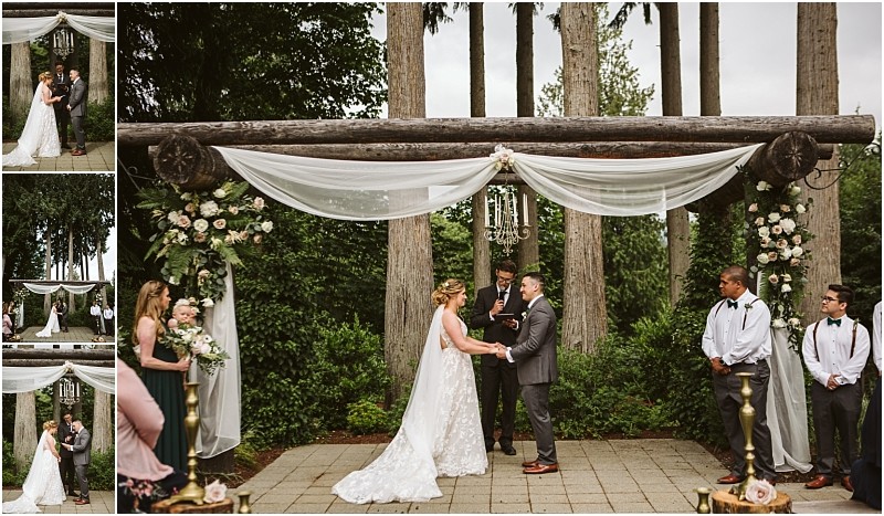 Premier snohomish & seattle wedding photographer | gsquared weddings photography a bride and groom stand under a wooden arbor decorated with white drapery and flowers holding hands during a beautiful snohomish outdoor wedding ceremony near seattle with the officiant and wedding party nearby | serving snohomish seattle                   & beyond