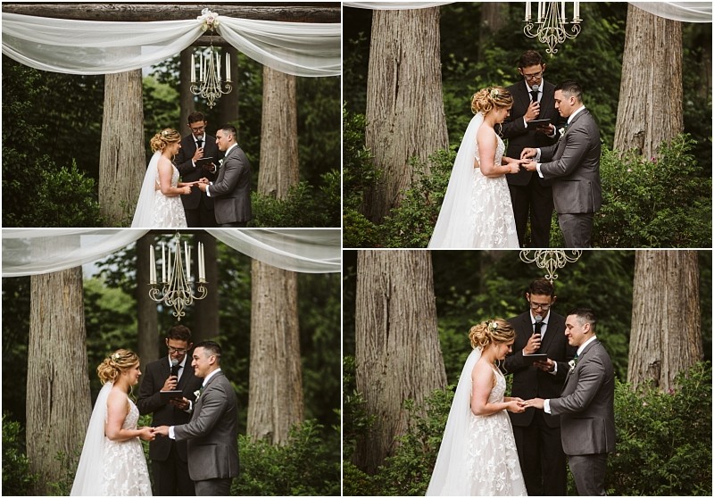Premier snohomish & seattle wedding photographer | gsquared weddings photography a bride and groom exchange rings during a snohomish outdoor wedding ceremony under a chandelier and draped fabric with a man officiating in the background among tall trees | serving snohomish seattle                   & beyond