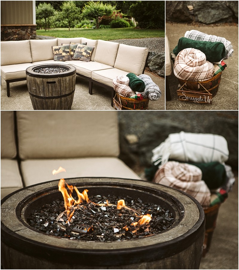 Premier snohomish & seattle wedding photographer | gsquared weddings photography a cozy outdoor patio perfect for a snohomish seattle wedding engagement featuring a beige sectional sofa a round fire pit with burning flames and a basket of rolled blankets Lush greenery and trees create a romantic backdrop | serving snohomish seattle                   & beyond