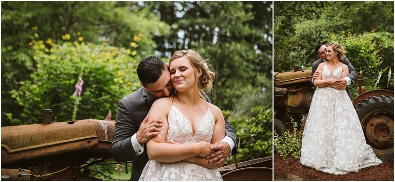 Premier snohomish & seattle wedding photographer | gsquared weddings photography a bride in a white lace dress and a groom in a dark suit embrace in front of a rusty tractor surrounded by green foliagea serene affectionate moment from their snohomish seattle wedding engagement | serving snohomish seattle                   & beyond
