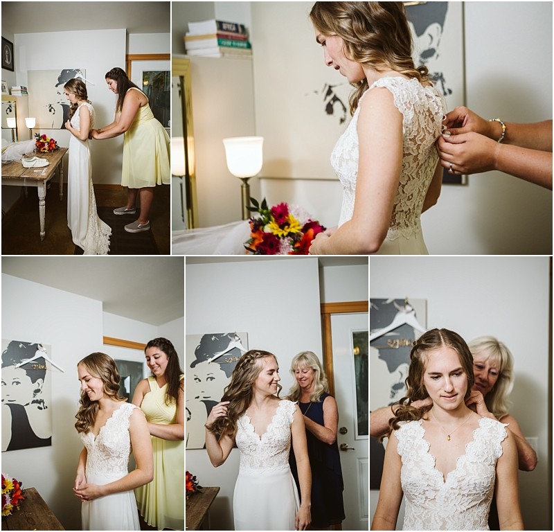 Premier snohomish & seattle wedding photographer | gsquared weddings photography a bride in a white lace dress gets ready for her snohomish wedding helped by women in a room with white walls wooden doors and black and white artwork She smiles and adjusts her hair before the seattle engagement begins | serving snohomish seattle                   & beyond