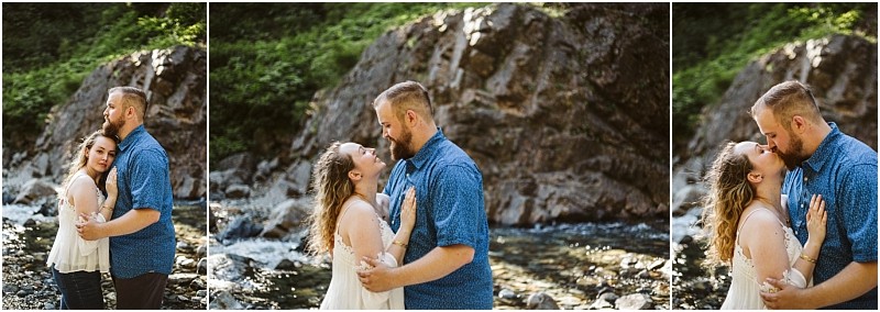 Premier snohomish & seattle wedding photographer | gsquared weddings photography a couple stands by a rocky riverbank near snohomish embracing and smiling lovingly at each other Behind them large rocks and green foliage bask in the bright sunlightperfect for a seattle wedding engagement moment | serving snohomish seattle                   & beyond