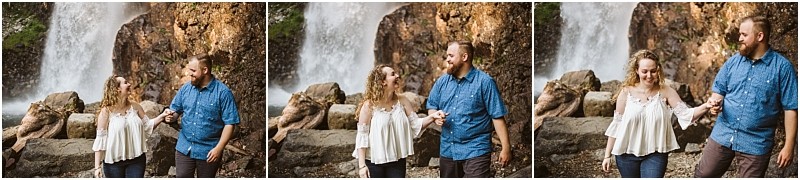 Premier snohomish & seattle wedding photographer | gsquared weddings photography a couple smiles and laughs together holding hands near a waterfall with large rocks and flowing water in the backgroundcapturing a joyful snohomish seattle wedding engagement moment | serving snohomish seattle                   & beyond