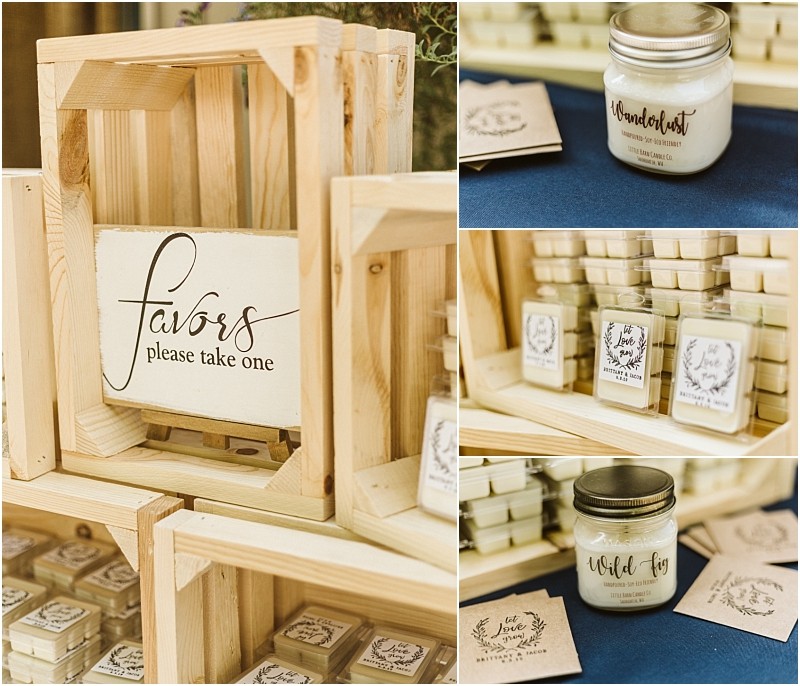 Wooden crates with a sign reading favors please take one display small candles in jars and wax melts each labeled with scents like wanderlust and wild fig at a charming snohomish event favor table Snohomish wedding photography