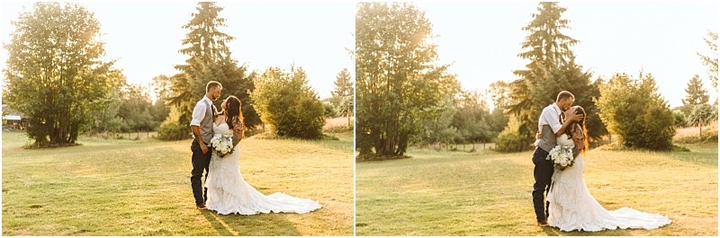 A bride and groom stand together in a sunlit snohomish grassy field surrounded by trees The bride holds a bouquet and wears a long white dress while the groom wears suspenders and a tie They embrace and share a kiss Snohomish wedding photography