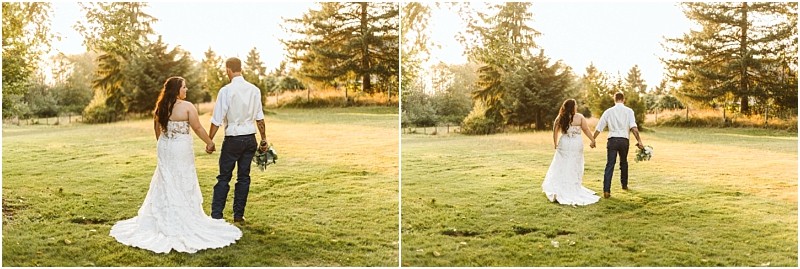 A bride in a white gown and a groom in a white shirt and dark pants walk hand in hand across a grassy snohomish field at sunset holding a bouquet with trees in the background Snohomish wedding photography