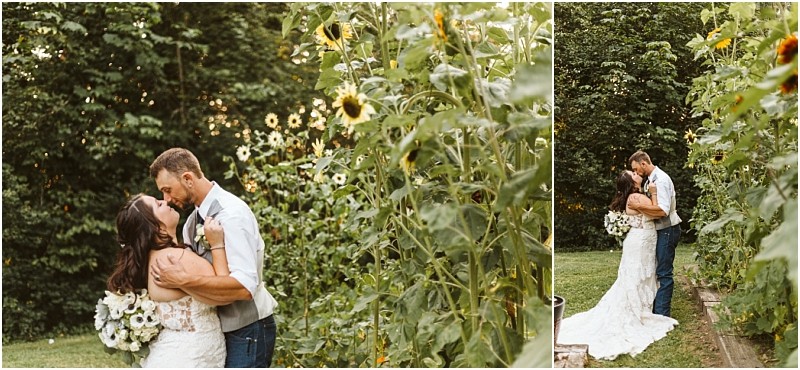 A bride and groom embrace and kiss in a snohomish garden surrounded by tall sunflowers and greenery with the bride holding a bouquet of white flowers Snohomish wedding photography