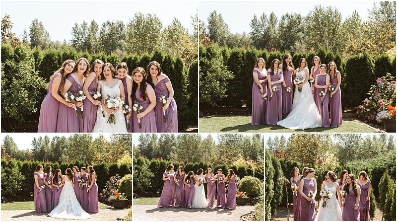 A bride in a white gown poses outdoors with six bridesmaids in matching lavender dresses smiling and laughing together amid the lush greenery and flowers of a scenic snohomish setting Snohomish wedding photography