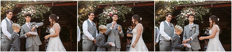 Three panel wedding photo a bride groom groomsmen and a ring bearer share a playful moment during the ring exchange outdoors in snohomish all smiling and laughing in front of a beautiful floral arrangement Snohomish wedding photography