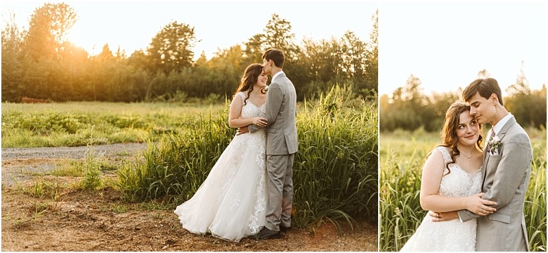 A bride in a white lace gown and a groom in a light gray suit embrace outdoors at sunset in snohomish standing in tall grass with trees behind them both smiling affectionately at each other Snohomish wedding photography