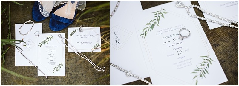 Wedding invitations with green leaf designs set in snohomish a diamond ring silver jewelry and blue shoes arranged on a rustic surface The invitations display the names cayla zahler & kyle duda and wedding details Snohomish wedding photography