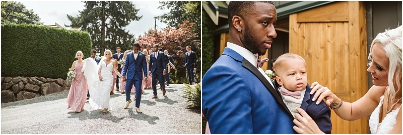 A wedding party walks outdoors in snohomish with bridesmaids in pink dresses and groomsmen in blue suits In a close up a woman adjusts a young boys outfit as a man holds him all dressed formally Snohomish wedding photography
