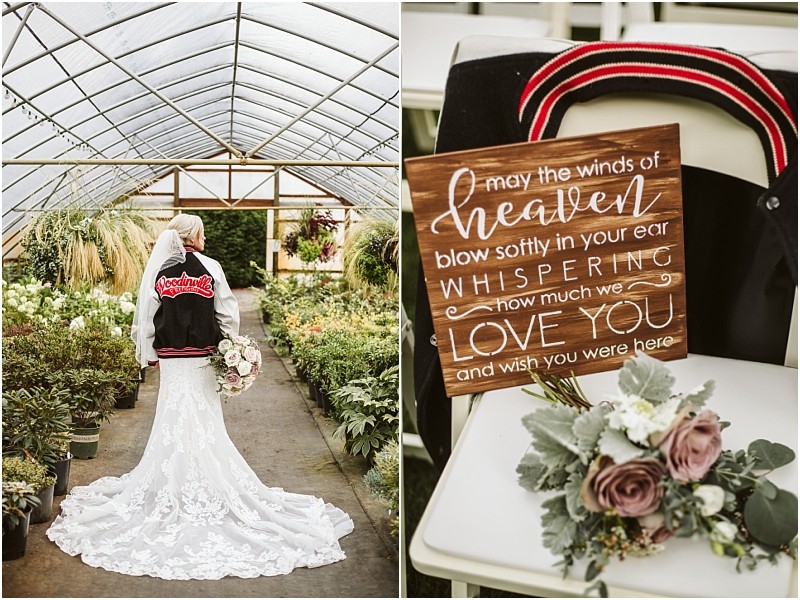 A bride in a lace gown and headscarf wears a varsity jacket in a snohomish greenhouse beside her a chair holds the same jacket a bouquet and a wooden sign reading may the winds of heaven blow softly in your ear Snohomish wedding photography