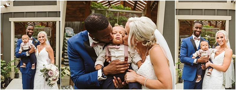 A bride and groom in wedding attire pose happily with their baby son in a picturesque snohomish garden The groom kisses the baby while the bride smiles capturing a joyful family moment Snohomish wedding photography