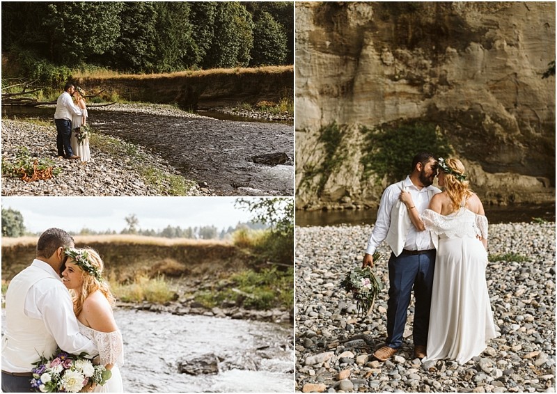 A bride and groom stand together on a rocky snohomish riverbank sharing intimate moments and holding hands surrounded by nature and cliffs in an outdoor setting Snohomish wedding photography
