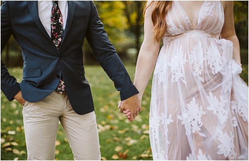 Premier snohomish & seattle wedding photographer | gsquared weddings photography a couple holds hands outdoors during their snohomish engagement the person on the left wears a dark blazer floral tie and light pants while the person on the right wears a sheer white dress with floral patterns Grass and trees are in the background | serving snohomish seattle & beyond Premier snohomish & seattle wedding photographer | gsquared weddings photography a couple holds hands outdoors during their snohomish engagement the person on the left wears a dark blazer floral tie and light pants while the person on the right wears a sheer white dress with floral patterns Grass and trees are in the background | serving snohomish seattle & beyond