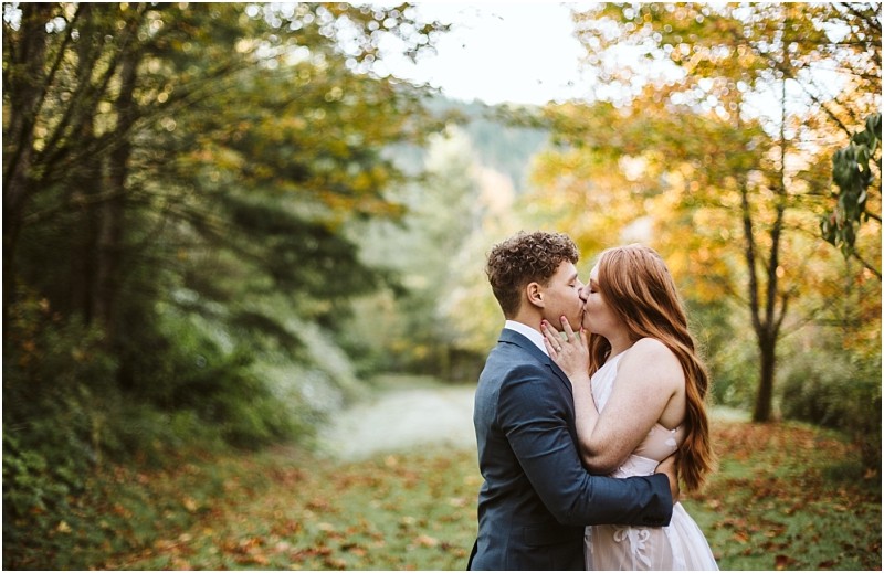 Premier snohomish & seattle wedding photographer | gsquared weddings photography a couple shares a romantic kiss in a forested area with autumn leaves during their snohomish engagement The person on the left wears a suit the person on the right wears a light dress surrounded by trees and greenery | serving snohomish seattle & beyond Premier snohomish & seattle wedding photographer | gsquared weddings photography a couple shares a romantic kiss in a forested area with autumn leaves during their snohomish engagement The person on the left wears a suit the person on the right wears a light dress surrounded by trees and greenery | serving snohomish seattle & beyond