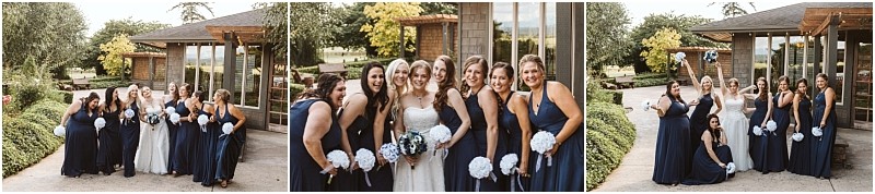 Premier snohomish & seattle wedding photographer | gsquared weddings photography a bride in a white dress poses outdoors with her bridesmaids in navy blue dresses holding white bouquets smiling and celebrating a snohomish seattle wedding in front of a modern building and lush greenery | serving snohomish seattle                   & beyond