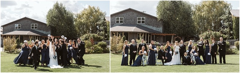 Premier snohomish & seattle wedding photographer | gsquared weddings photography a wedding party poses on a grassy lawn in front of a house in snohomish bridesmaids wear navy dresses groomsmen wear black suits and the group celebrates with raised bouquets and joyful expressions | serving snohomish seattle                   & beyond