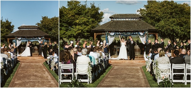 Premier snohomish & seattle wedding photographer | gsquared weddings photography a beautiful snohomish wedding ceremony outdoors with a bride and groom standing under a wooden gazebo surrounded by their wedding party and guests seated on white chairs along an aisle lined with lush greenery | serving snohomish seattle                   & beyond