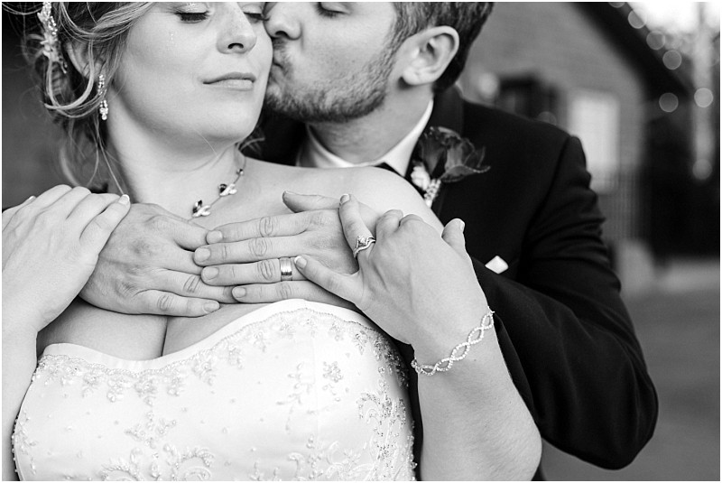 Premier snohomish & seattle wedding photographer | gsquared weddings photography a groom gently kisses the bride on her cheek holding her hands over her chest The bride wears a strapless wedding gown and jewelry This black and white image captures a romantic atmosphere at their snohomish seattle wedding | serving snohomish seattle                   & beyond