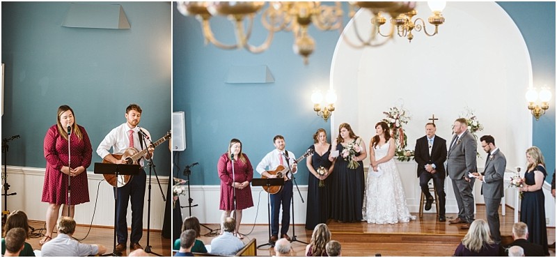 Premier snohomish & seattle wedding photographer | gsquared weddings photography a beautiful snohomish wedding ceremony takes place in a church On the left a man with a guitar and a woman sing to guests On the right the wedding party stands on stage near flowers and an officiant | serving snohomish seattle                   & beyond