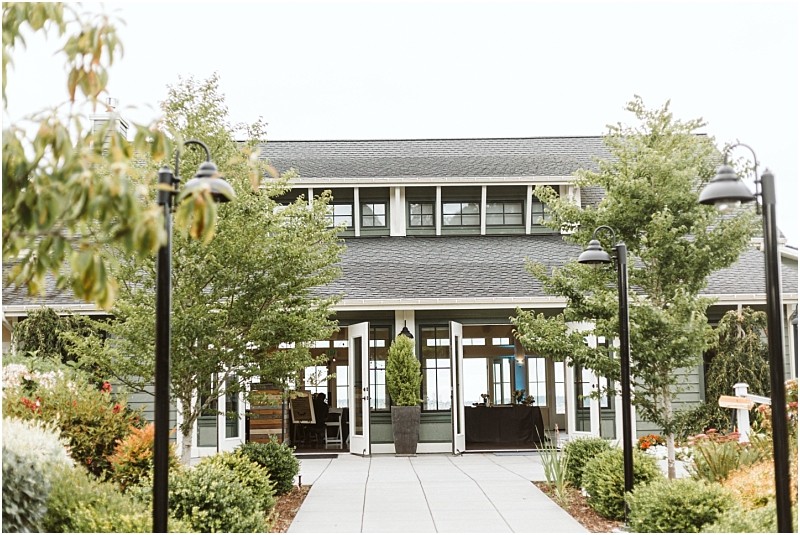 Premier snohomish & seattle wedding photographer | gsquared weddings photography a path lined with black lamp posts and trees leads to a modern building with large windows and a covered porchan ideal snohomish seattle wedding or engagement venue surrounded by green shrubs and colorful flowers | serving snohomish seattle                   & beyond