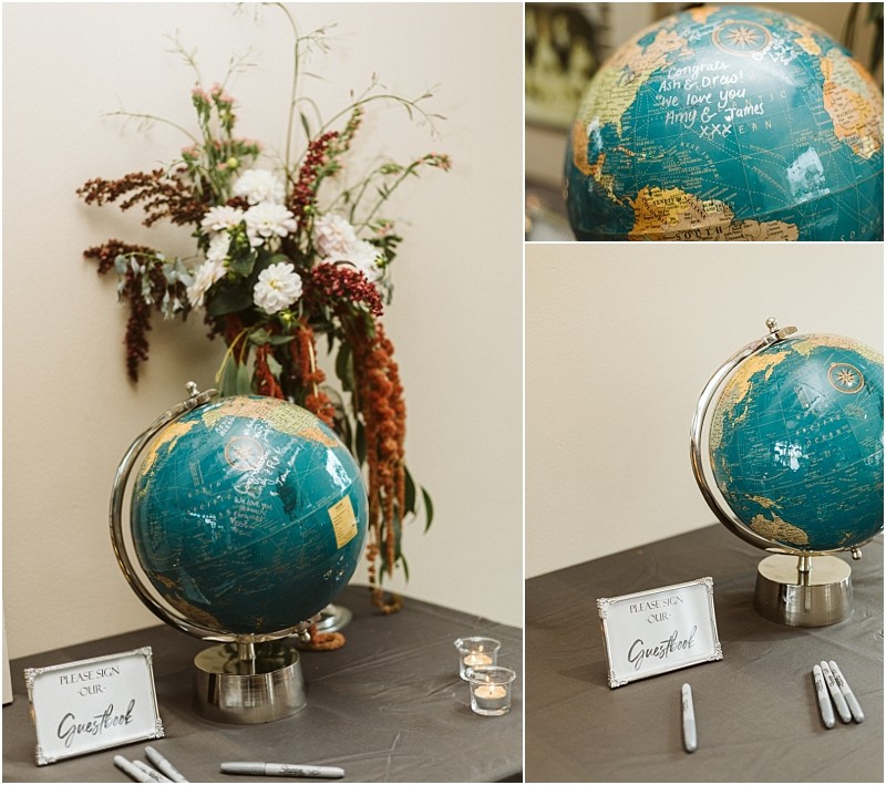 Premier snohomish & seattle wedding photographer | gsquared weddings photography a globe with handwritten messages sits on a table with pens and a please sign our guestbook signperfect for your snohomish or seattle wedding or engagement Behind the globe is a floral arrangement with white pink and red flowers | serving snohomish seattle                   & beyond