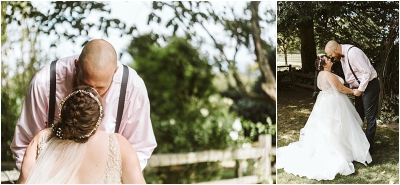Premier snohomish & seattle wedding photographer | gsquared weddings photography a bride and groom share a tender moment outdoors during their snohomish seattle wedding the groom in a pink shirt and suspenders kisses his bride beneath the shade of trees in a sunlit garden setting | serving snohomish seattle                   & beyond